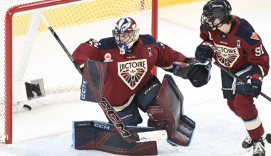 A women's hockey goalie fails to stop a goal.