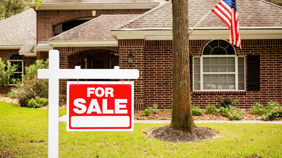 Home with a "for sale" sign