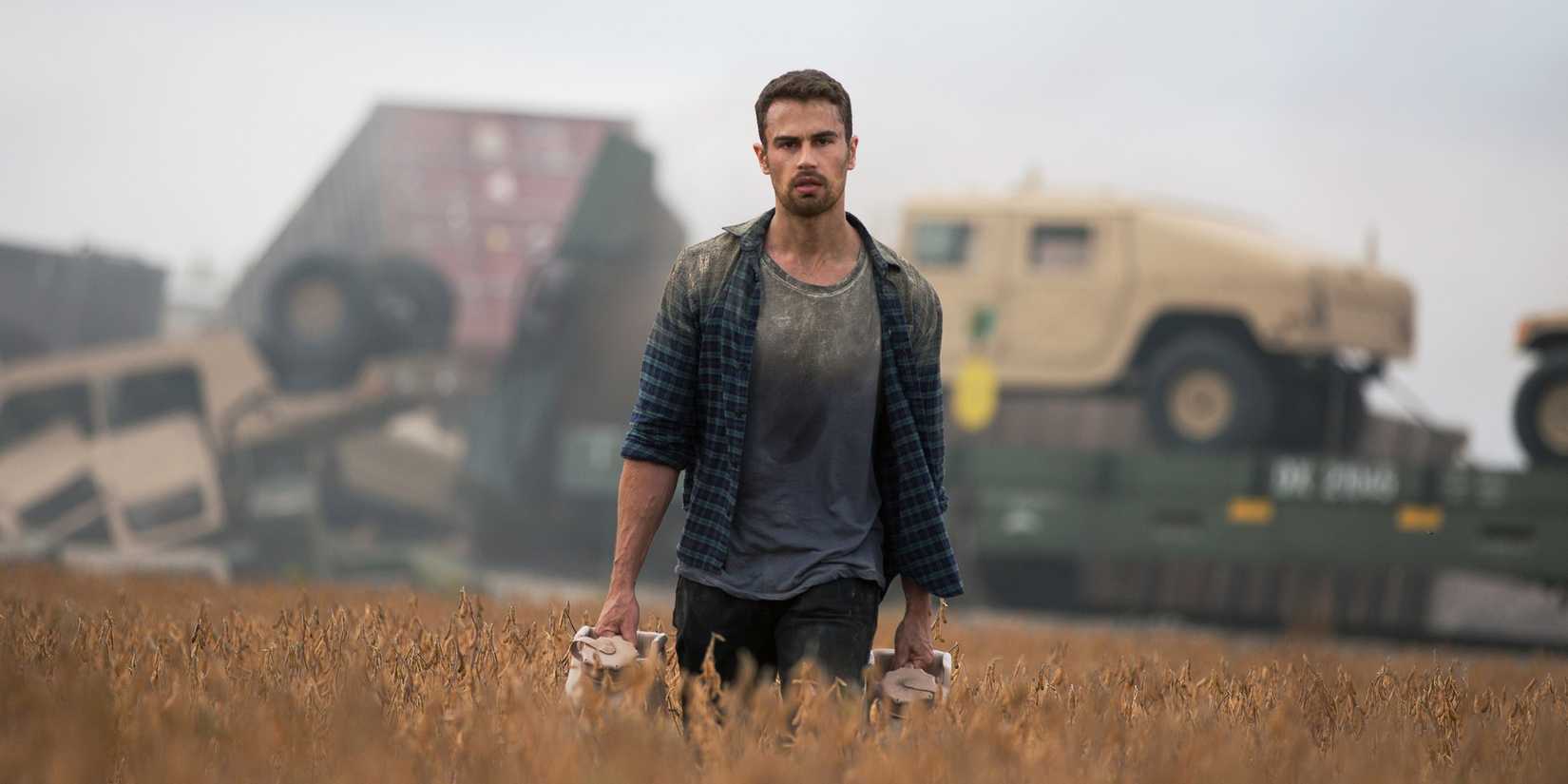 Theo James walking across a field in How It Ends