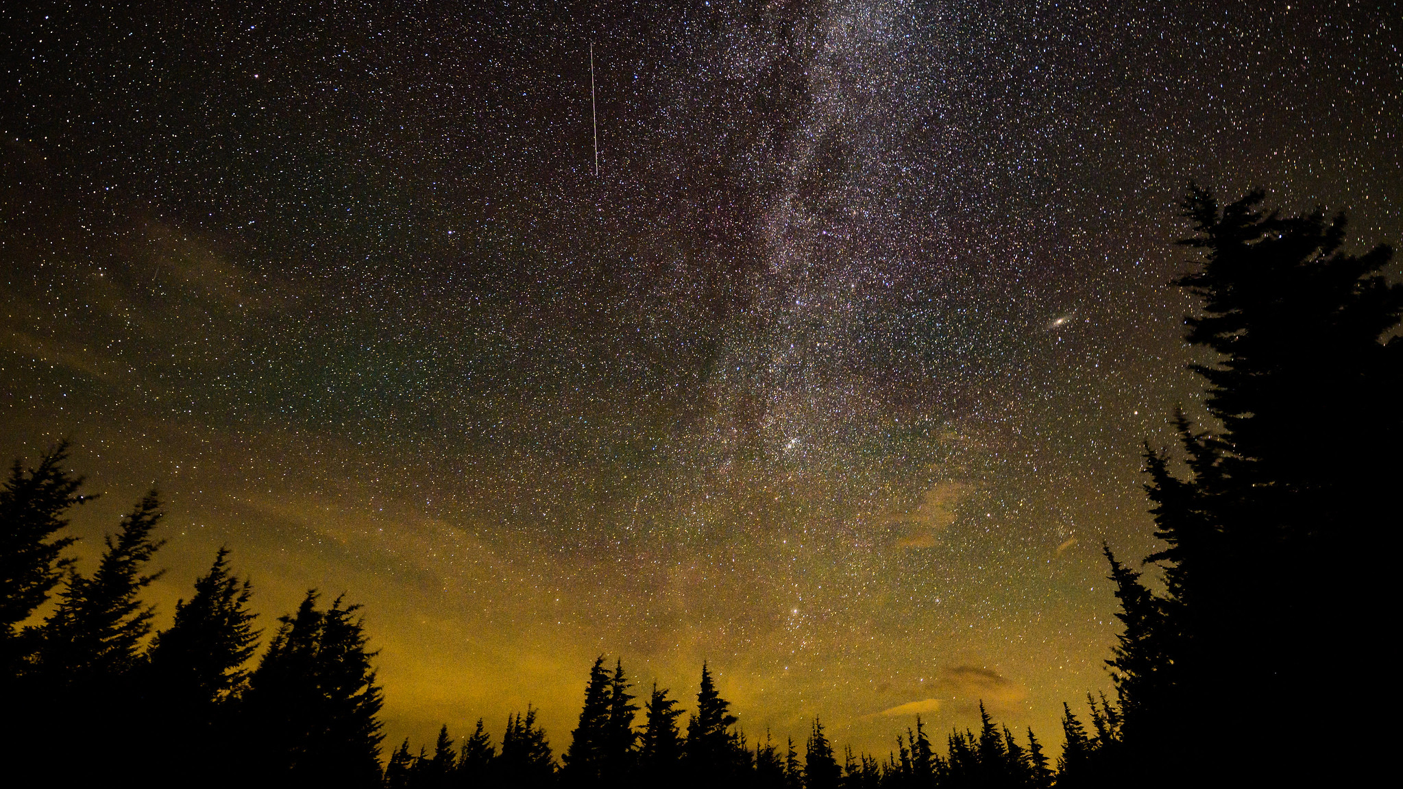In this 30 second exposure, a meteor streaks across the sky during the annual Perseid meteor shower, Wednesday, Aug. 11, 2021, in Spruce Knob, West Virginia.