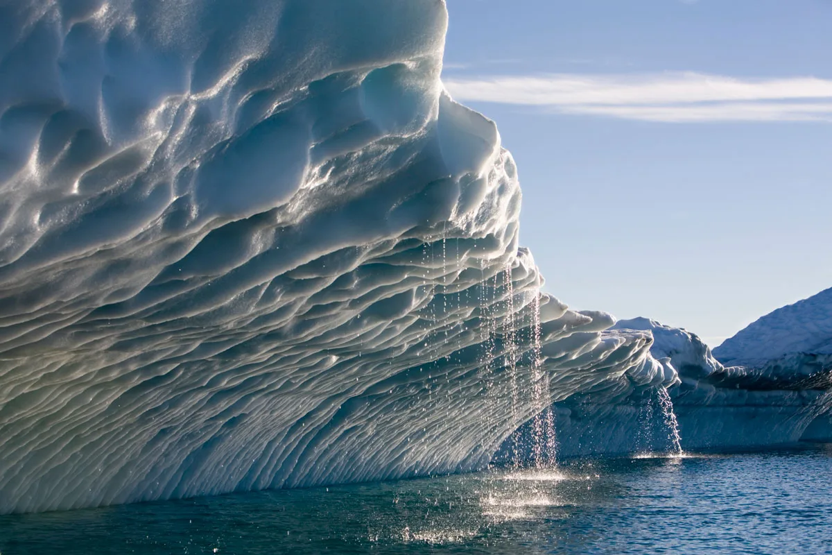 Melting water streams from iceberg.