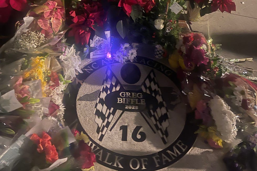 Greg Biffle Walk of Fame tribute with floral arrangements at a memorial site