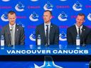 Canucks co-presidents Henrik Sedin (left) and Daniel Sedin (centre), along with general manager Ryan Johnson, address the media on Thursday at Rogers Arena.