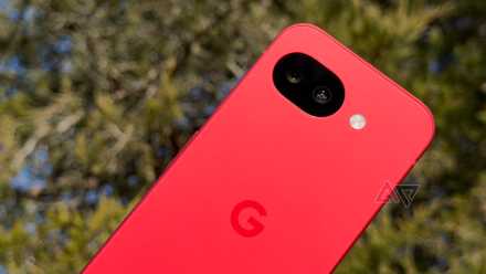 Google Pixel 10a held up against a green tree