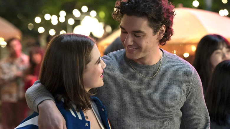Garrett with his arm around Hannah, smiling in 