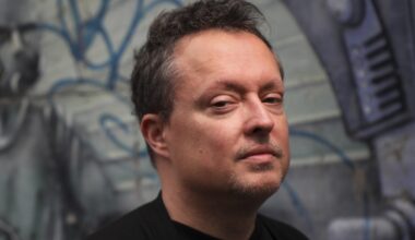 Mike Ward poses for a photo in front of some graffiti.
