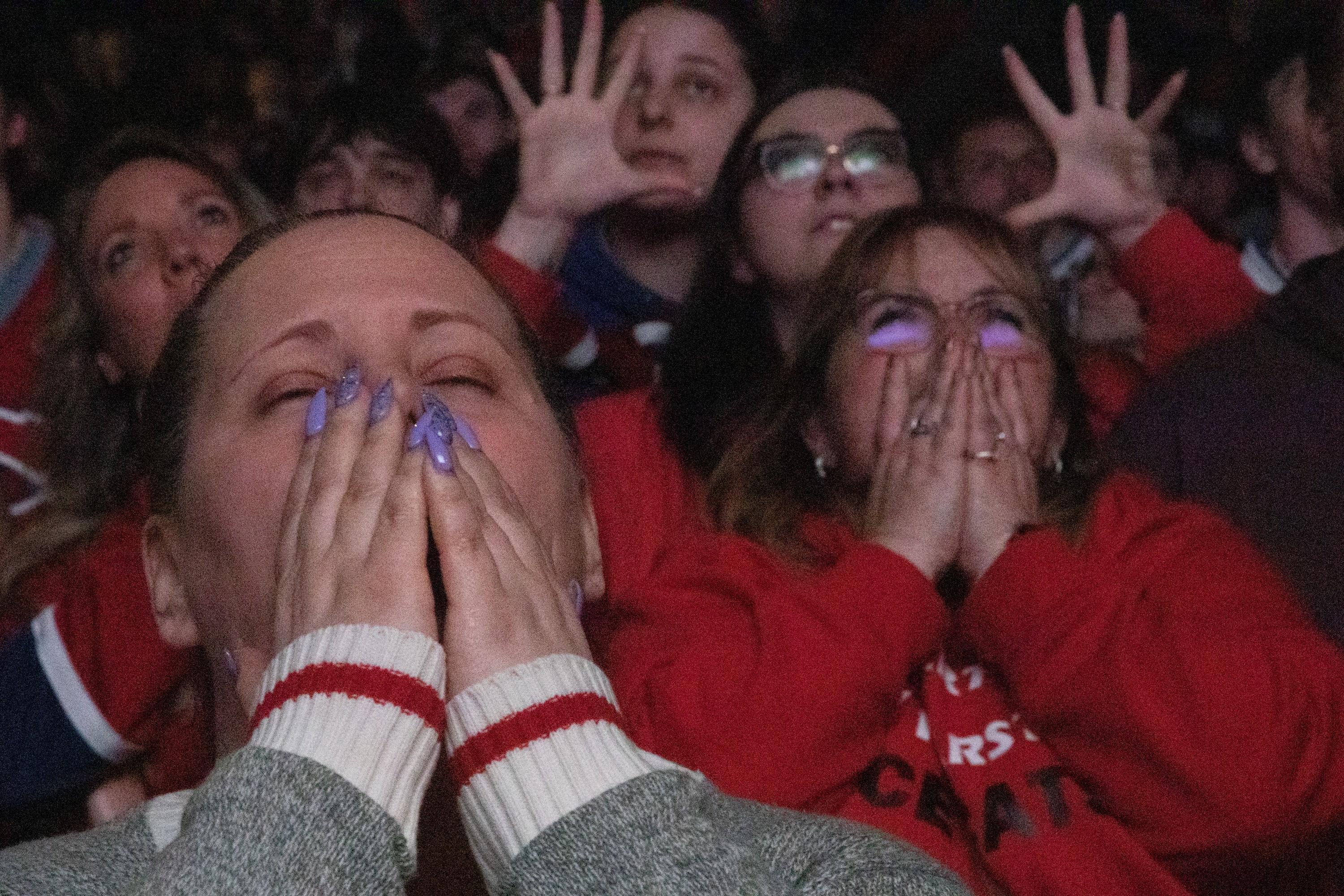 Montreal Canadiens fans react with intense emotions at an outdoor watch party.
