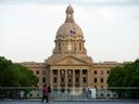 Pedestrians walk through the Alberta Legislature grounds after the polls closed in the 2023 provincial election, in Edmonton Monday May 29, 2023. 