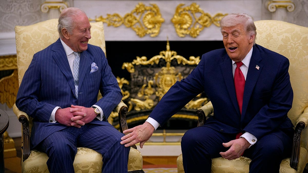 U.S. President Donald Trump touching King Charles III in the Oval Office