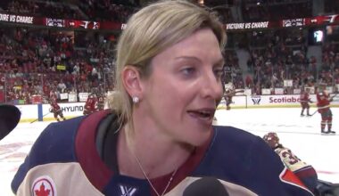 Laura Stacey does an interview on TV while on the ice.