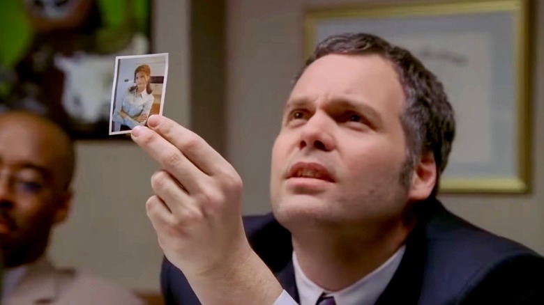 Robert Goren holding up a photograph and speaking