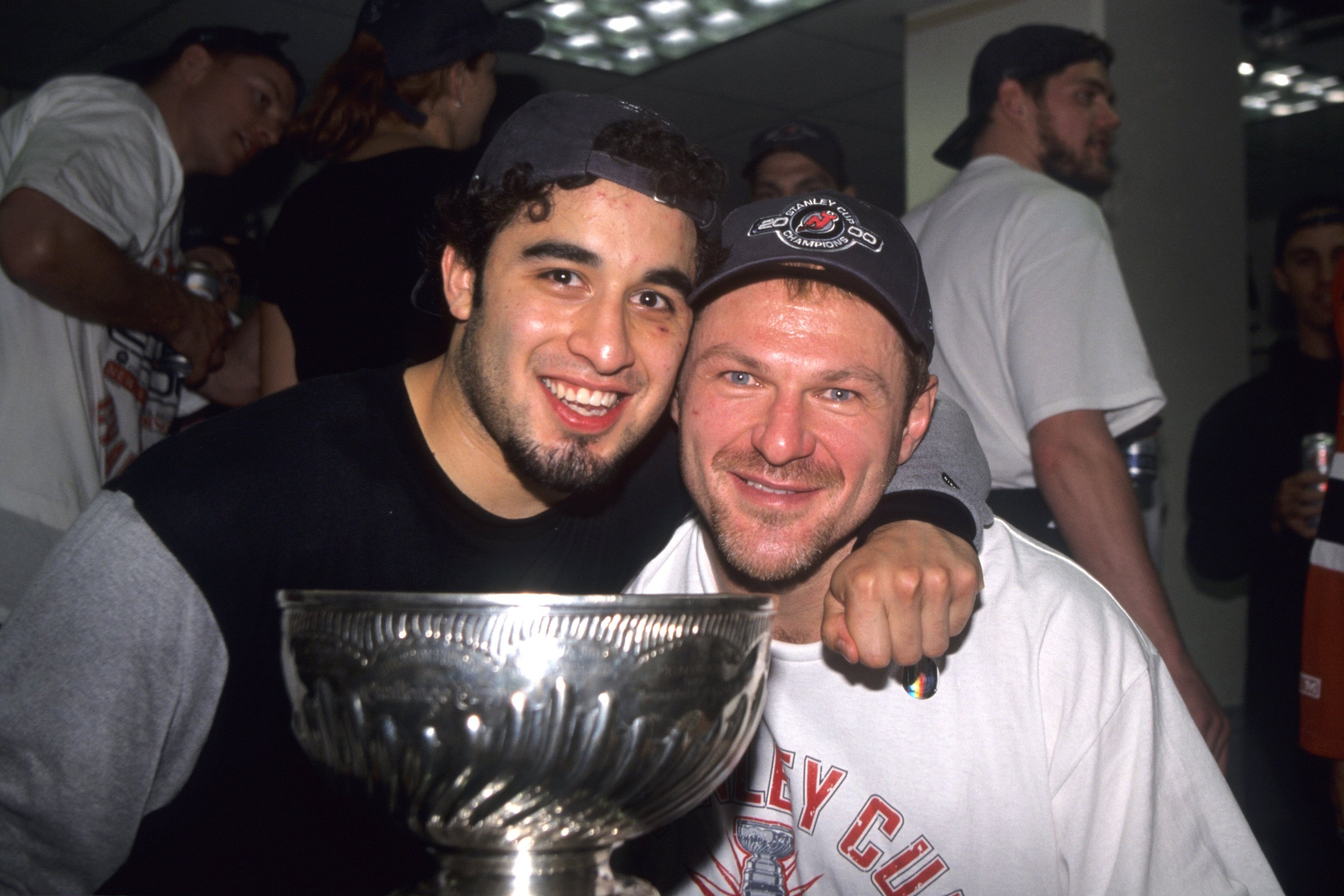 Claude Lemieux of the New Jersey Devils and Scott Gomez celebrate with the Stanley Cup after winning the 2000 Stanley Cup Finals game against the Dallas Stars on June 10, 2000.