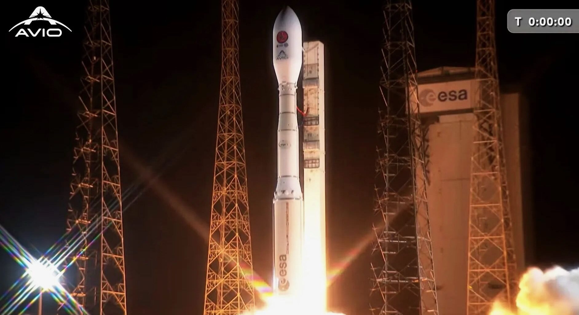 a white rocket launches into a dark night sky