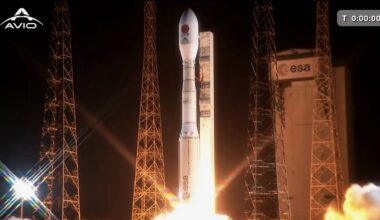 a white rocket launches into a dark night sky