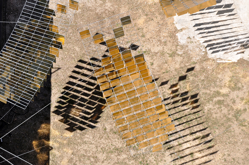 kinetic mirrored installation in portugal by moradavaga evokes a shoal of golden fish - 4