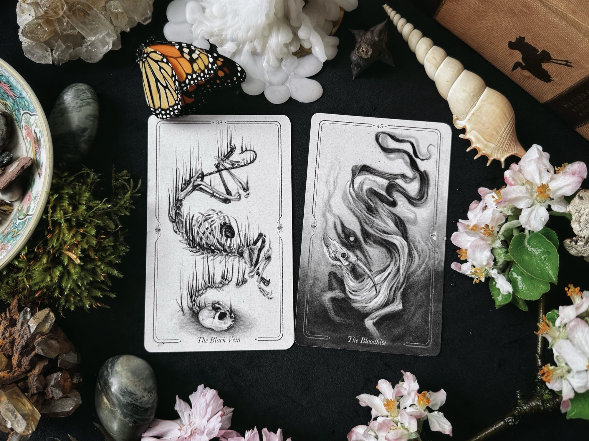two oracle cards on a black table