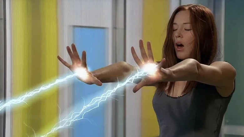 Moya O'Connell as Ashley Elliot beaming lightning from her hands in Mutant X