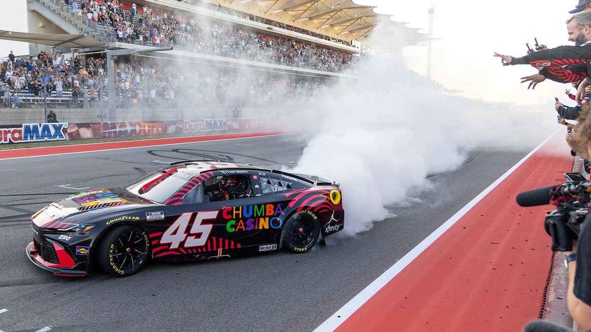 Tyler Reddick celebrating with team members at NASCAR race in Austin Texas
