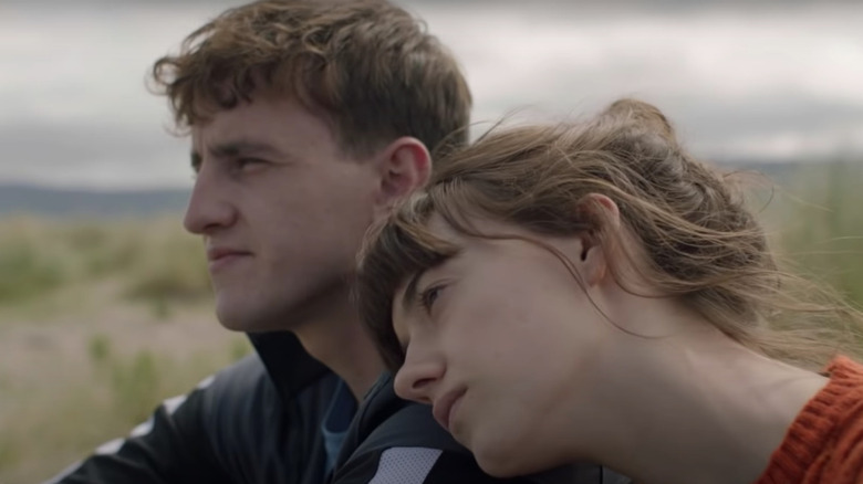 Daisy Edgar-Jones as Marianne leaning her head against Paul Mescal as Connell in Normal People