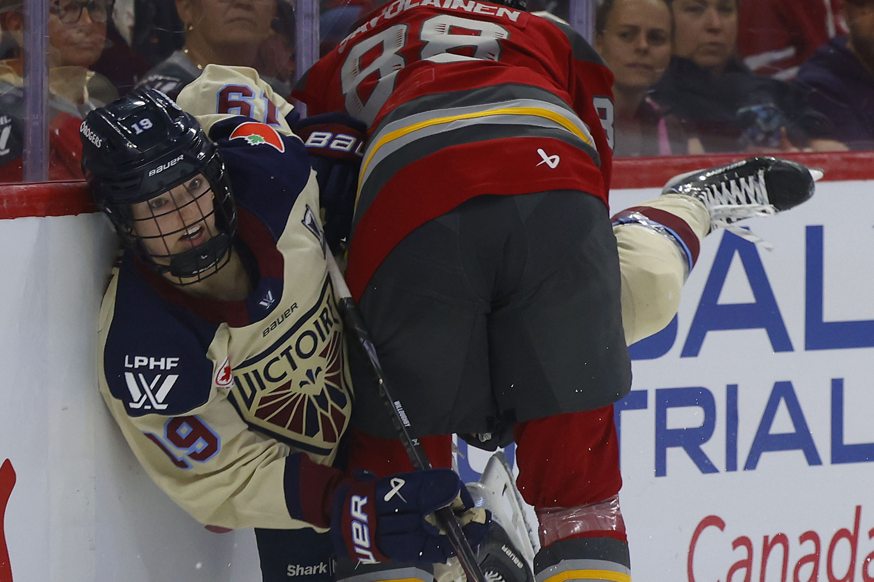 Kaitlin Willoughby is crunched into the boards almost horizontal by Ottawa Charge's Ronja Savolainen