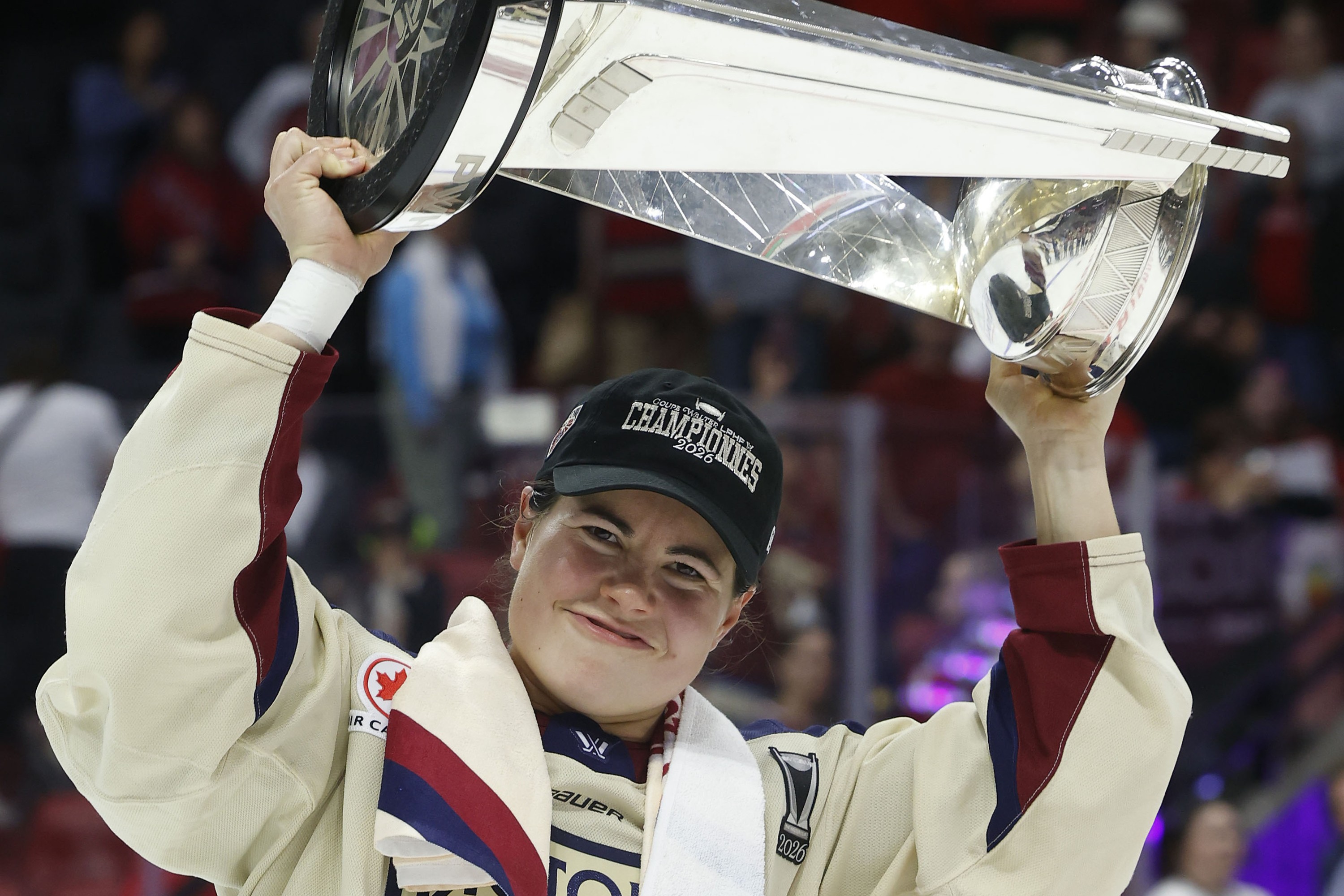Abby Roque smiles while hoisting the Walter Cup.