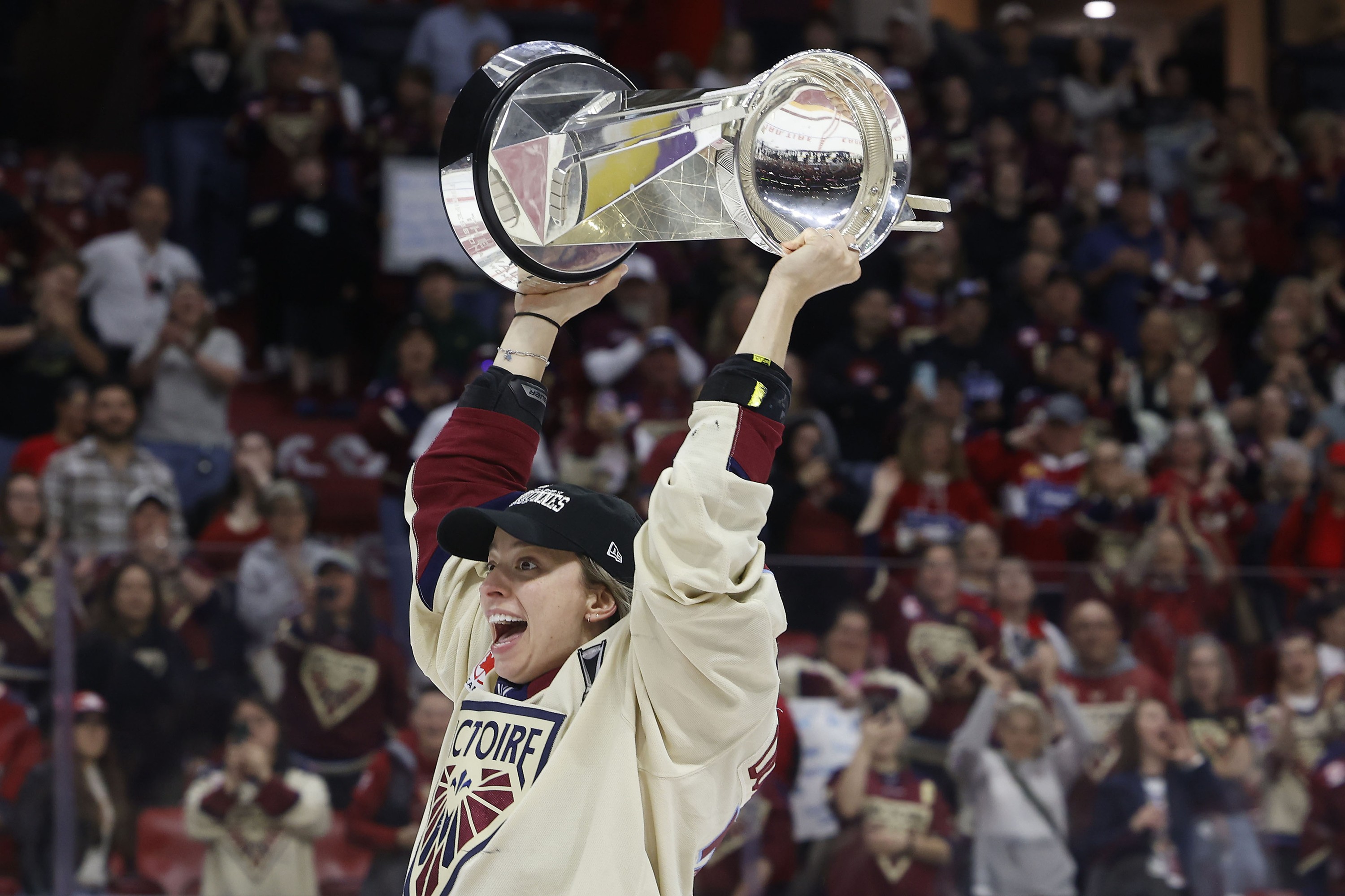 Montreal Victoire's Jade Downie-Landry hoists the Walter Cup.