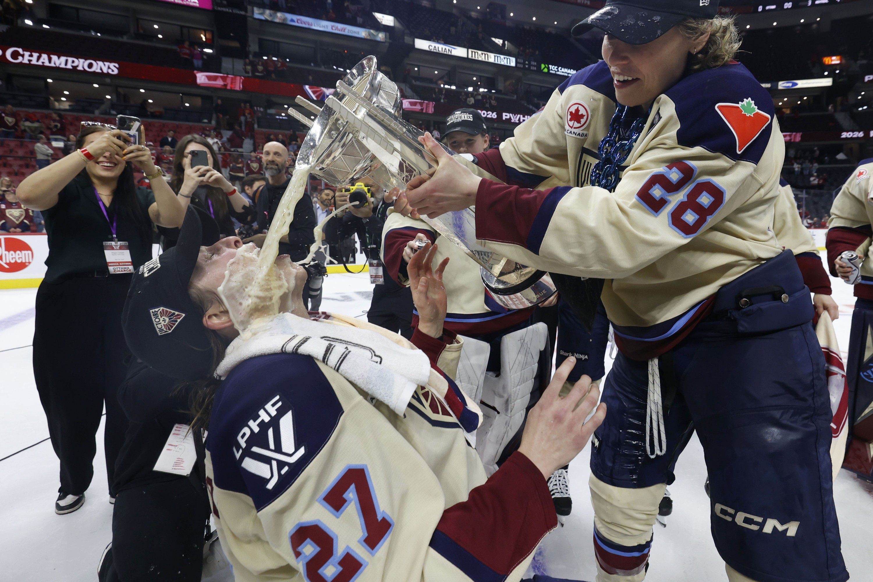 Montreal Victoire's Shiann Darkangelo has beer poured into her mouth and on her face.