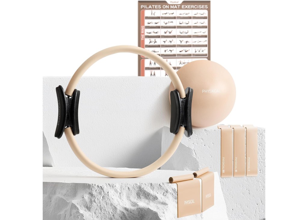 A Pilates set including a resistance ring, exercise ball, resistance bands, and a poster with mat exercises.