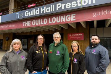 Members of the Preston Musical Comedy Society outside the Guild Hall