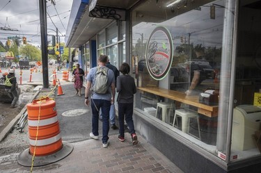 Pedestrians walk past Burrata Pizza on W. 41st Street in Kerrisdale.