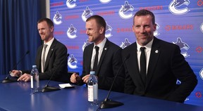 Henrik (l) and Daniel Sedin alongside Ryan Johnson as the club announces the appointments of the Sedins as co-presidents and Johnson as general manager at Rogers Arena in Vancouver on May 14, 2026.