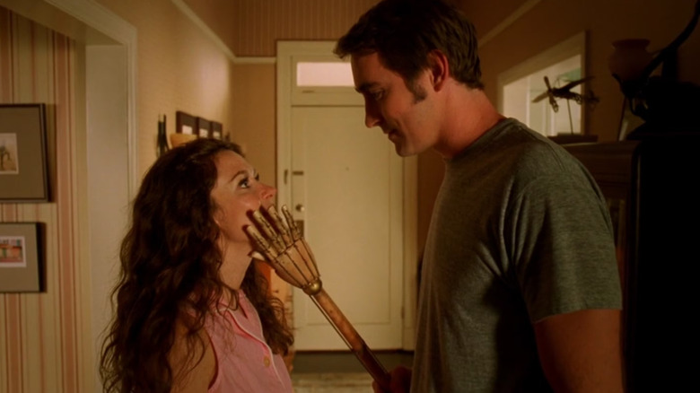 Lee Pace as Ned touching Anna Friel as Chuck's face with a wooden hand in Pushing Daisies