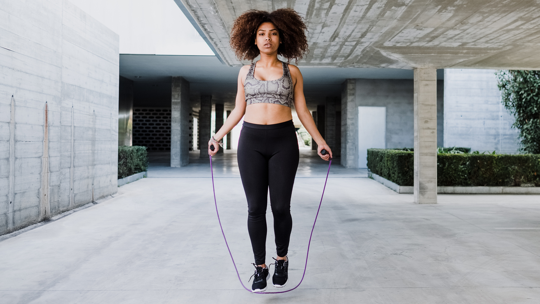 Woman exercising with jump rope outdoors