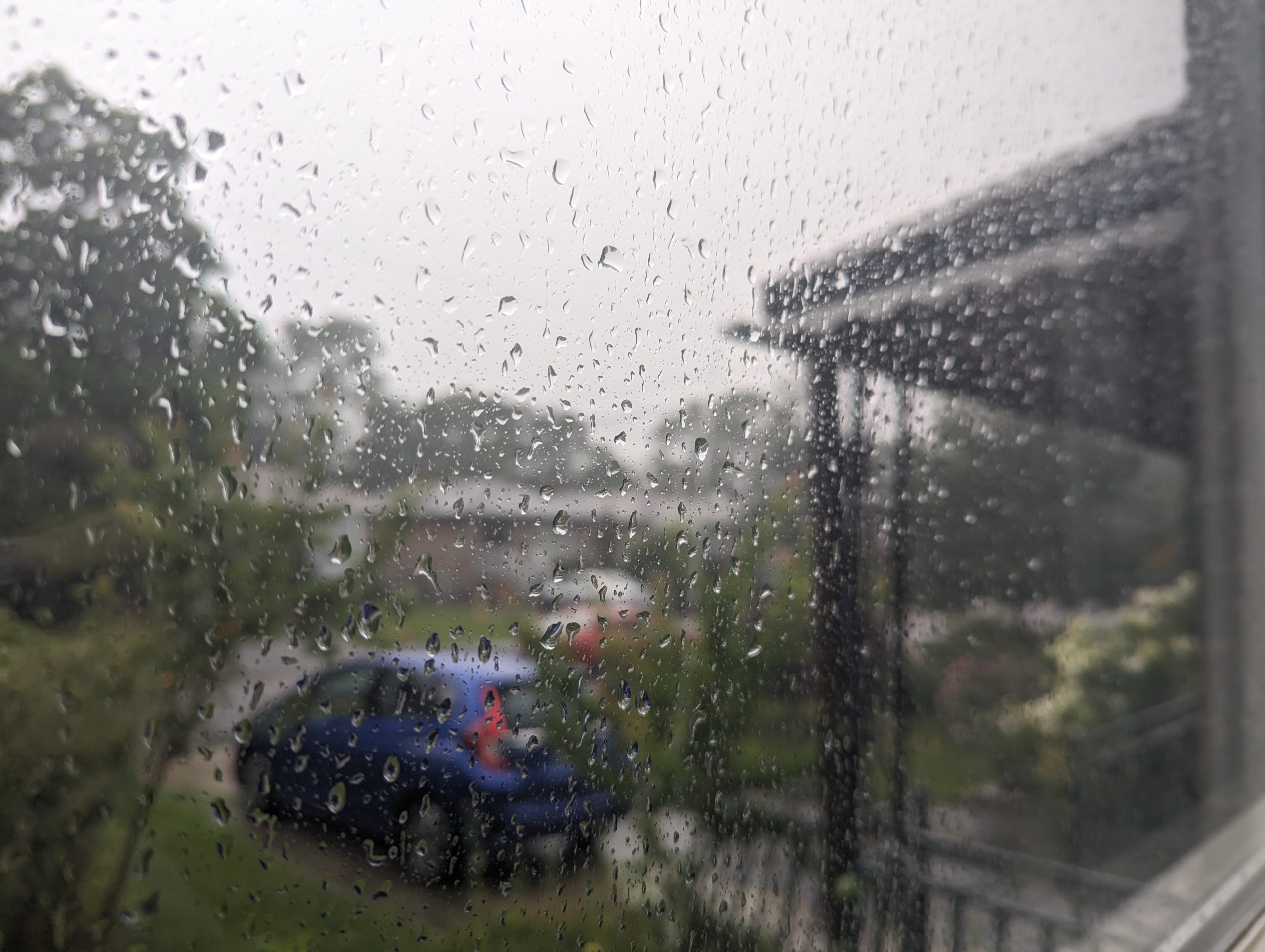 car in a driveway during a rainstorm