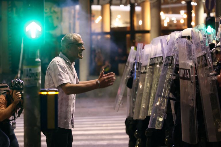 A man speaks to riot police, during a student-led protest demanding snap parliamentary elections, as Serbia's anti-corruption movement enters a new phase, following the Novi Sad railway station canopy collapse that killed 16 people in 2024, in Belgrade, Serbia, May 23, 2026. REUTERS/Zorana Jevtic