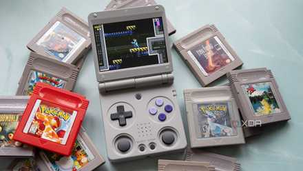 The RG 34XXSP sitting on a table beside Game Boy games