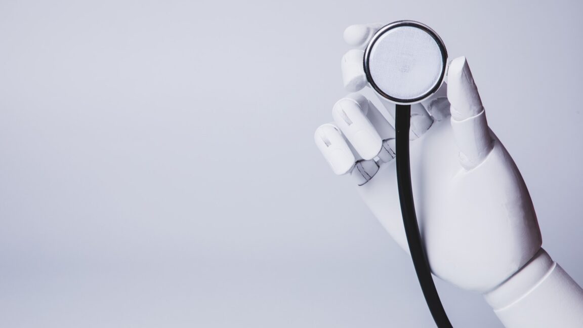 A robot hand holding a stethoscope.