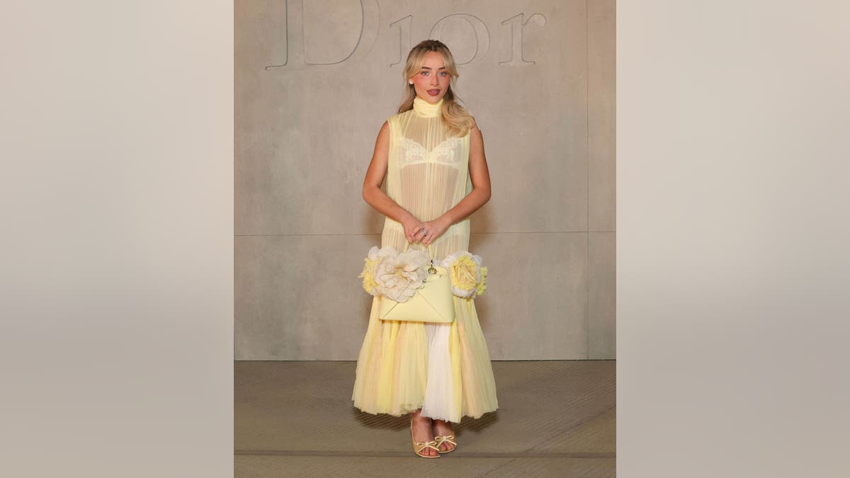 Sabrina Carpenter wearing a yellow dress at the Dior Cruise 2027 event in Los Angeles