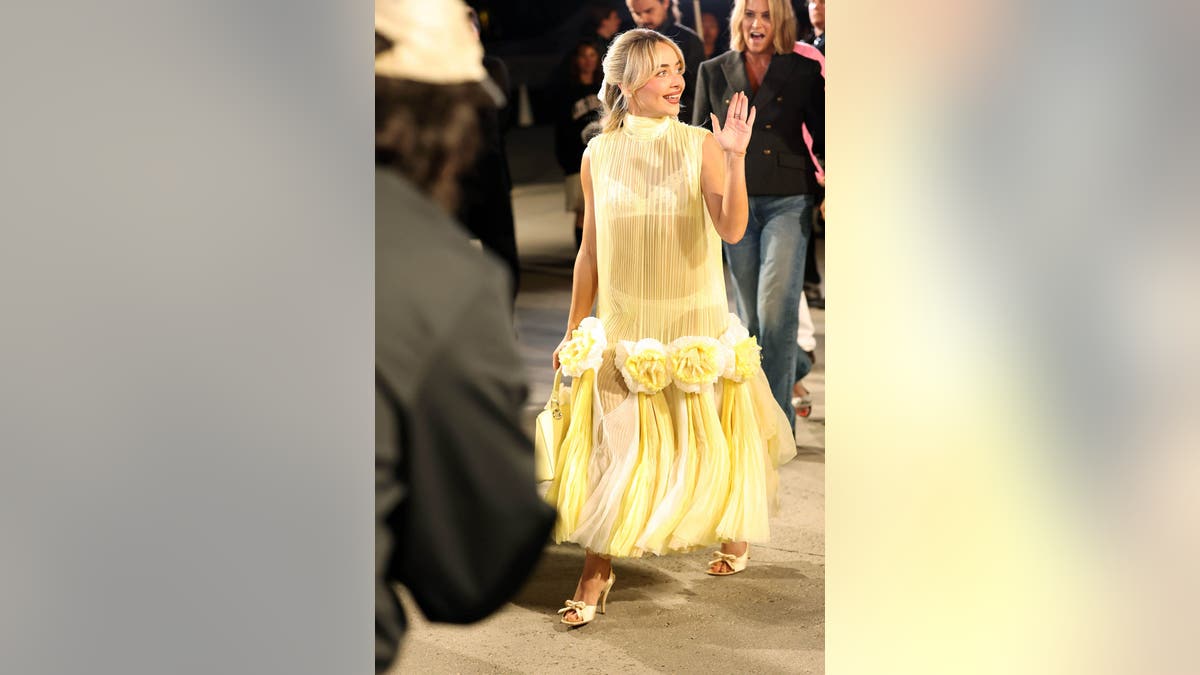 Sabrina Carpenter wearing a yellow dress at the Dior Cruise Show in Los Angeles