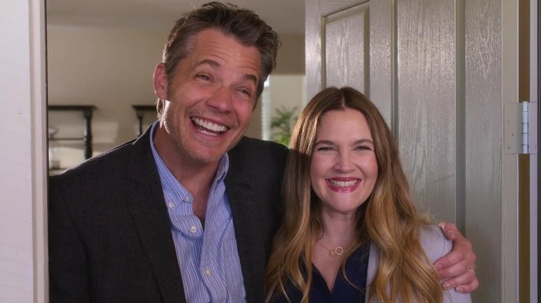 Timothy Olyphant and Drew Barrymore as Joel and Sheila smiling in a doorway in Santa Clarita Diet
