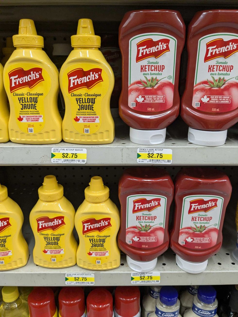 Shelves with bottles of ketchup and mustard