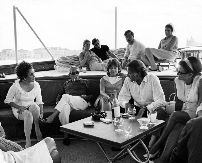 Elizabeth Taylor and Richard Burton with Aristotle Onassis and his son Alexander aboard The Christina O in March 1975.
