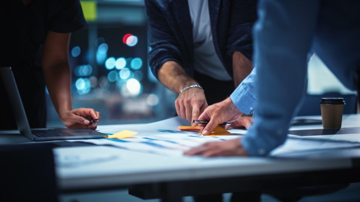 People in an office working on something at a desk