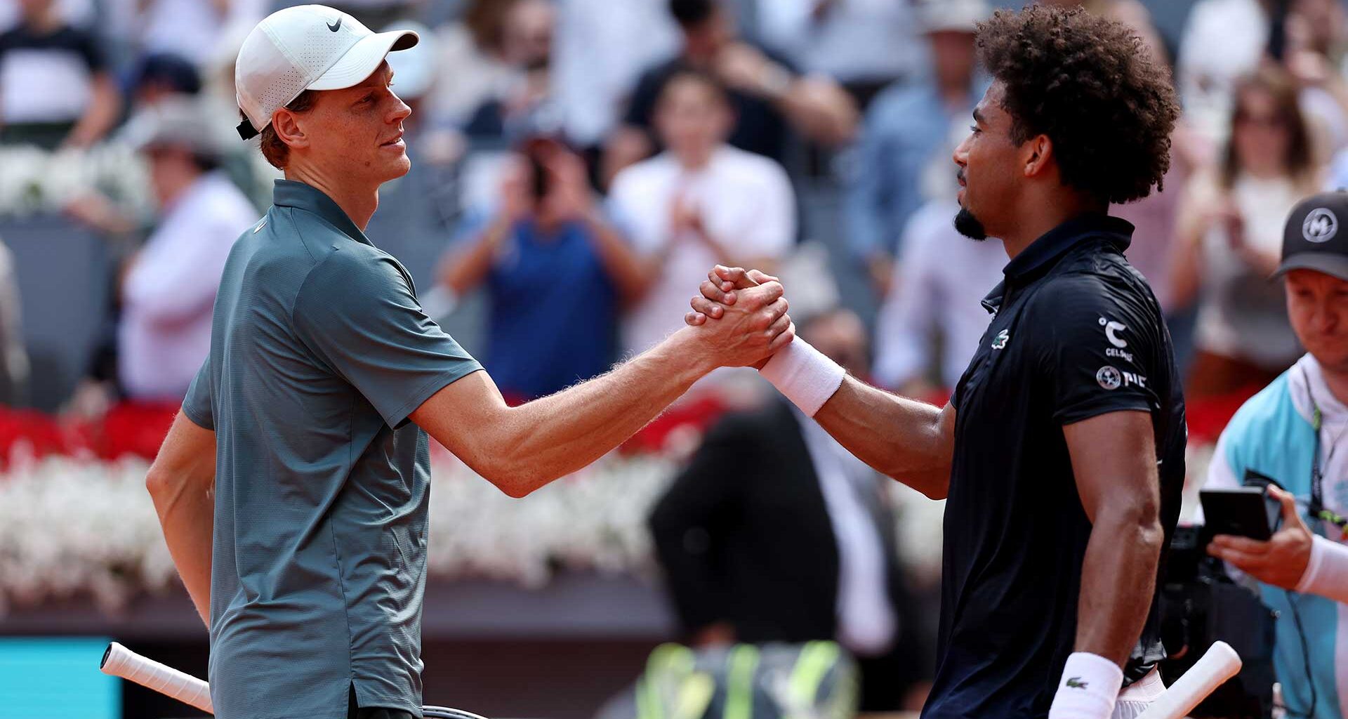 Jannik Sinner and Arthur Fils embrace following their Madrid semi-final on Friday.