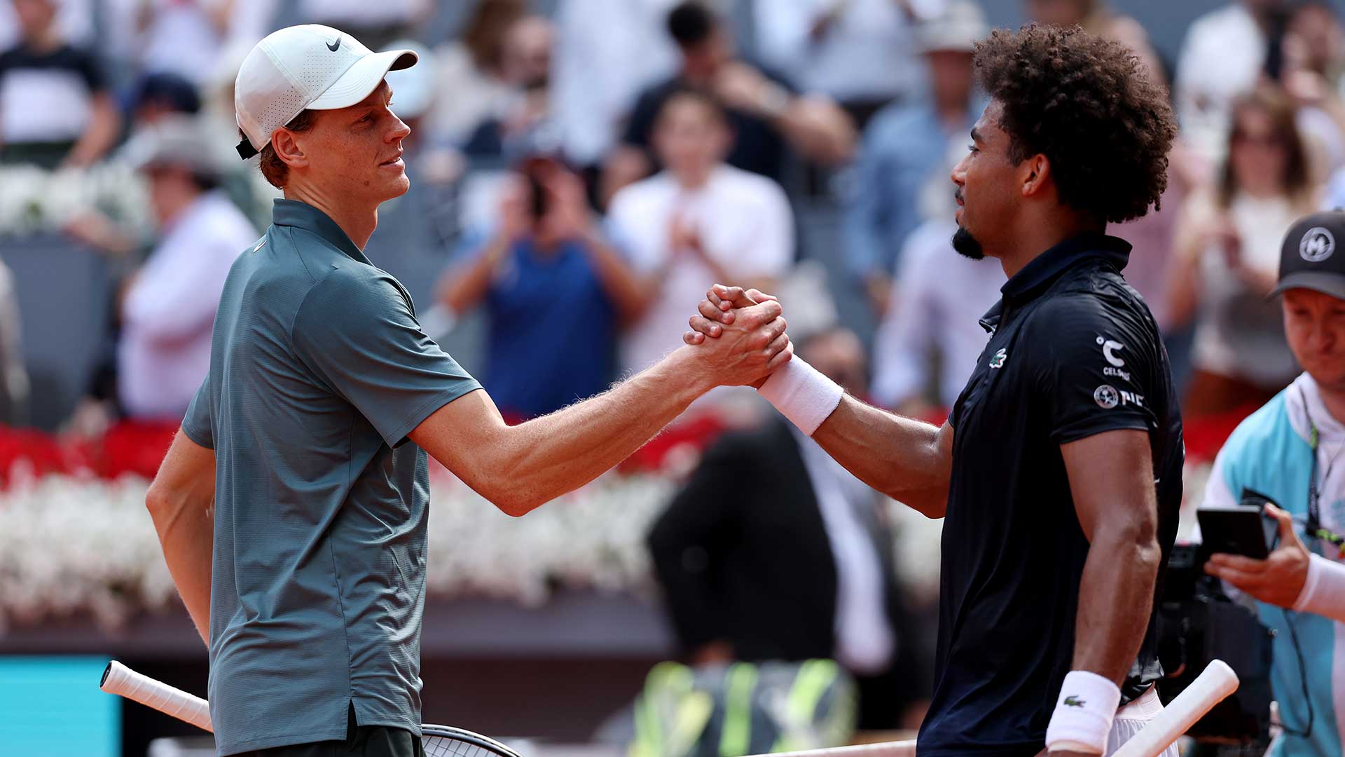 Jannik Sinner and Arthur Fils embrace following their Madrid semi-final on Friday.