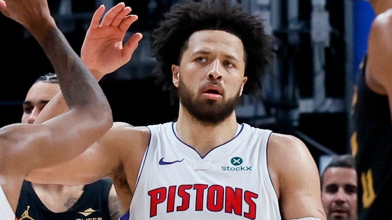Detroit Pistons guard Daniss Jenkins (24) celebrates a win with guard Cade Cunningham (2) as Cleveland Cavaliers center Evan Mobley, right, walks by during the final minute of Game 2 of a second-round NBA playoffs basketball series Thursday, May 7, 2026, in Detroit. (AP Photo/Duane Burleson)
