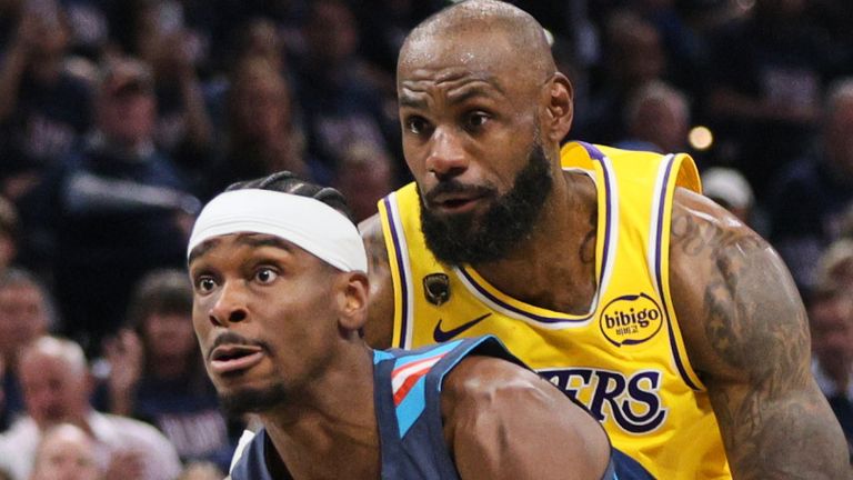Oklahoma City Thunder guard Shai Gilgeous-Alexander (2) drives to the basket past Los Angeles Lakers' Deandre Ayton (5) and LeBron James, rear, in the second half of Game 2 in a second-round NBA basketball playoffs series Thursday, May 7, 2026, in Oklahoma City. (AP Photo/Nate Billings)