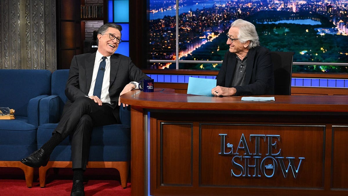 Stephen Colbert and Robert De Niro seated on The Late Show set