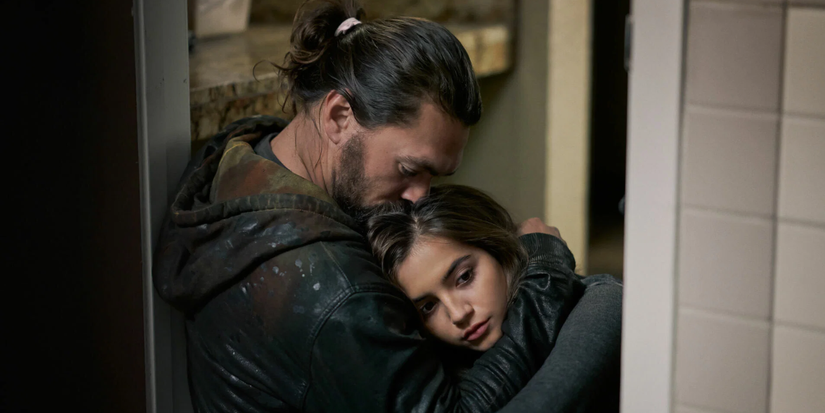 A man hugs his daughter tightly
