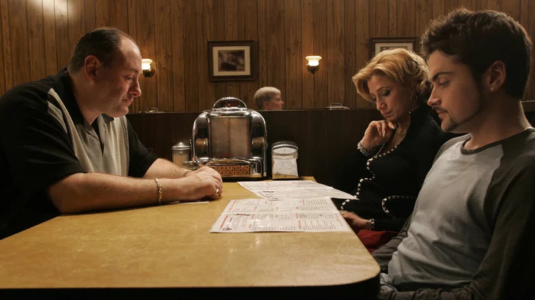 Tony Soprano, Carmela, and A.J. sit at a diner table